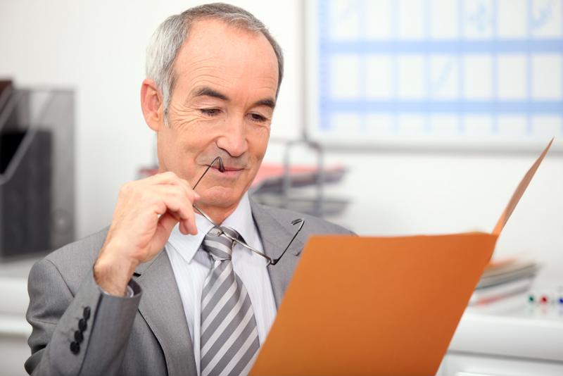 Older man with folder in hands