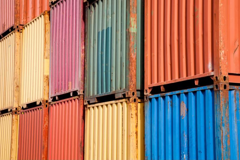 Stack of different colored shipping containers.