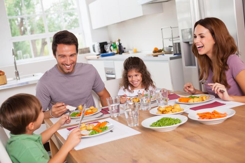 The dining table often serves as a gathering place outside of meal times.