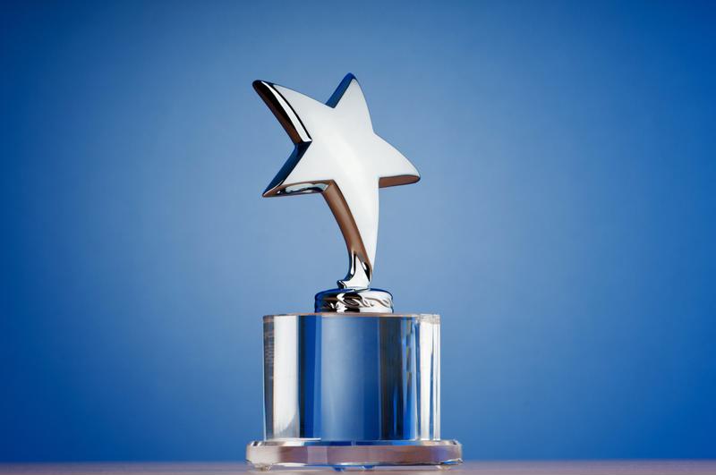 Star trophy against a blue backdrop.