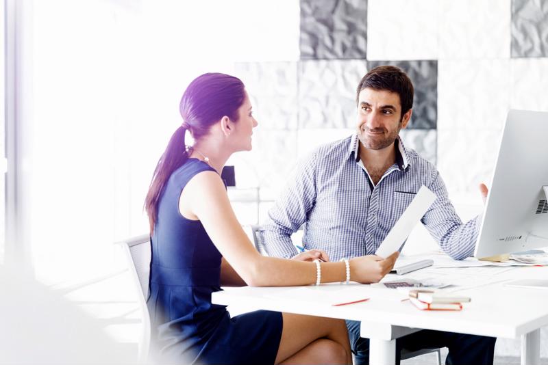 Man and woman working together in a conference room.