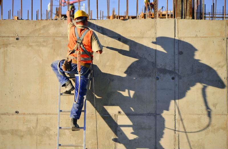 Construction worker climbing ladder. 