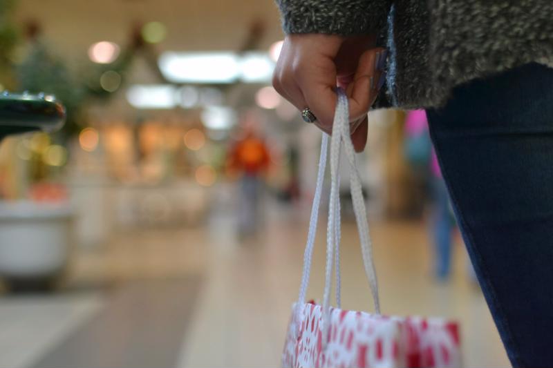Woman carrying a shopping bag in the mall.